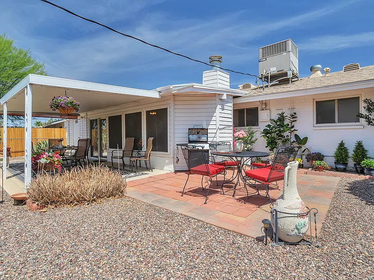 Large covered patio, gas grill, two patio table sets and abundant orange trees in your fully fenced yard.
