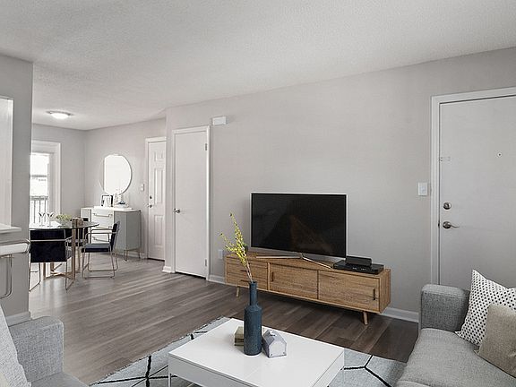 Experience the elegance of urban living with this sophisticated and comfortable living room setup.