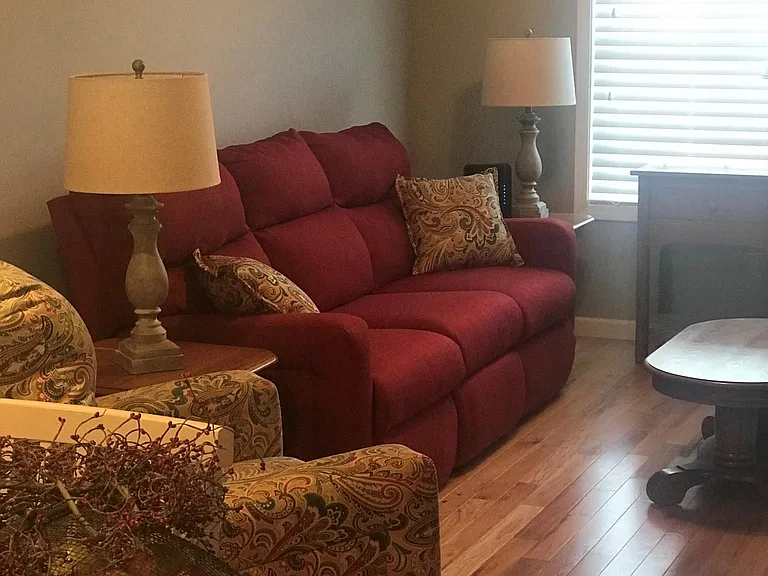 Beautiful hardwood floors, couch w/recliners and a recliner.