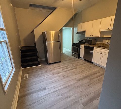 great large kitchen with gas stove, dishwasher, fridge and microwave stainless appliances and a pantry!