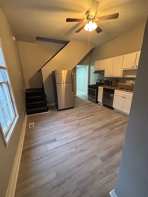 great large kitchen with gas stove, dishwasher, fridge and microwave stainless appliances and a pantry!
