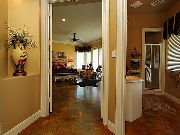 The entry leads to the den with formal dining on the right and the master bedroom, 4th bedroom or study and guest bathroom to the left