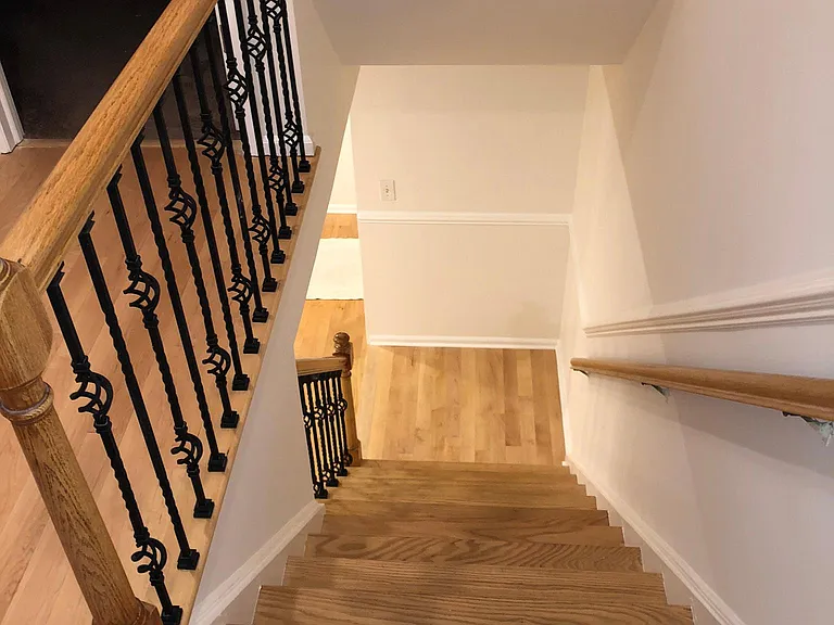 Second-floor hallway with hardwood flooring throughout.