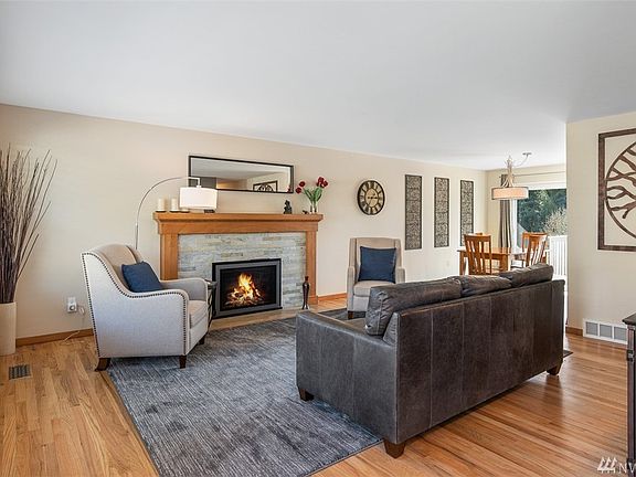 Refinished hardwood floors, gas fireplace and large picture window in living room 