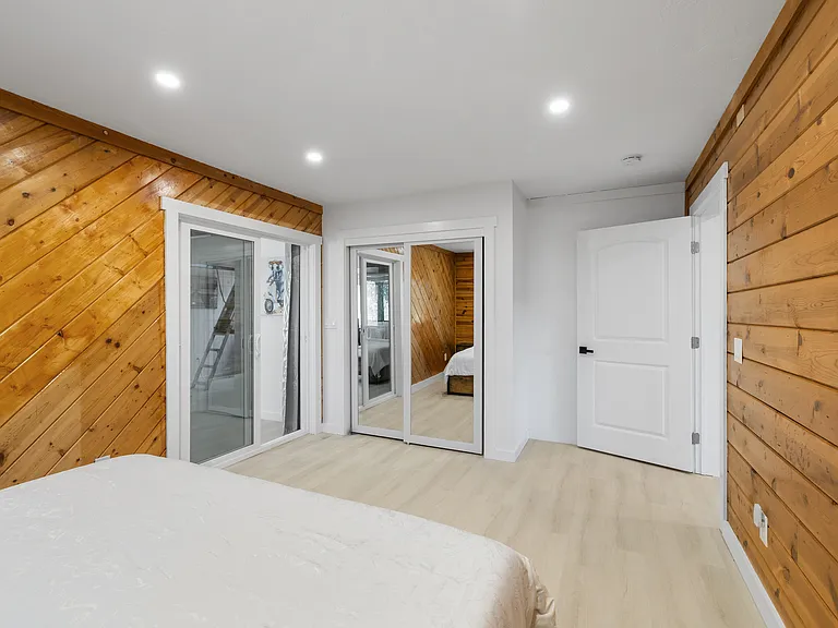 Downstairs Queen. Sliding glass door has curtain for privacy if desired.
