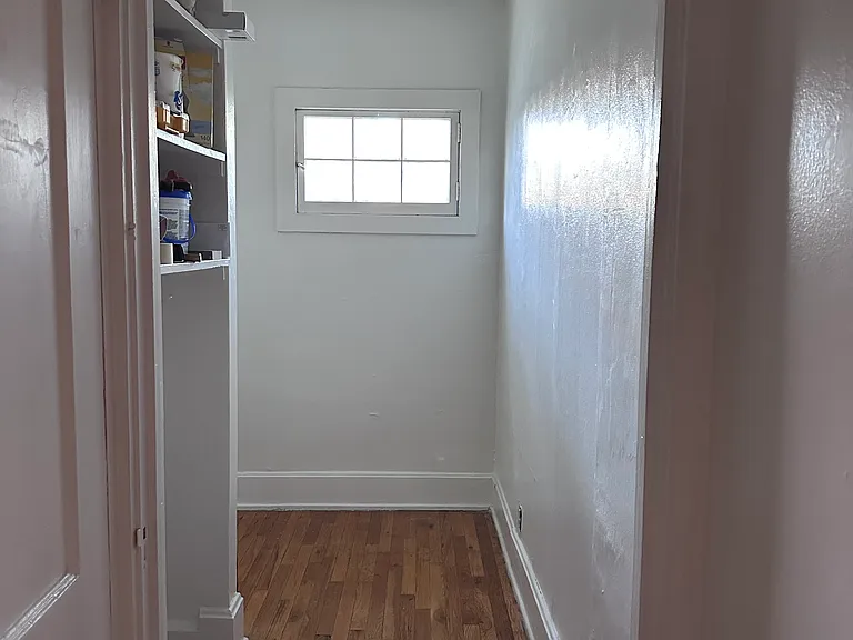 small bonus room with window and shelves, could be great as an office, closet, or storage area