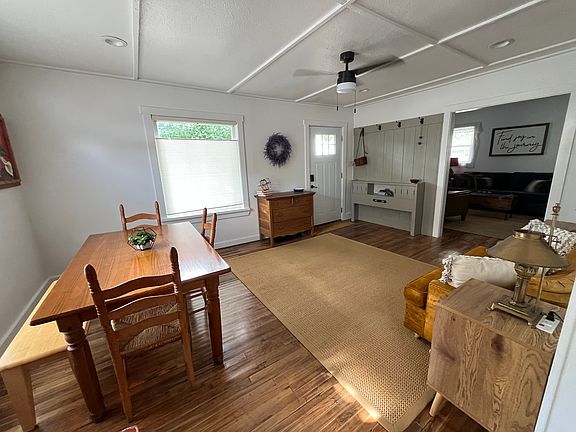 View of the entryway, living room and dining area from the kitchen door way.