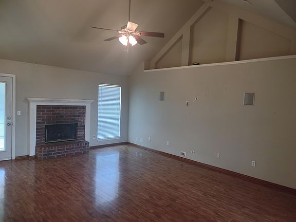 Living room with gas fireplace and prewired wall with wall mounted speakers for flat screen TV