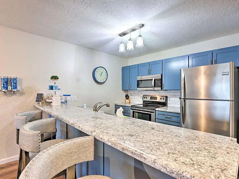Beautifully updated kitchen, fully furnished and stocked with cooking ware, oven, dish-washer, stainless steel refrigerator,