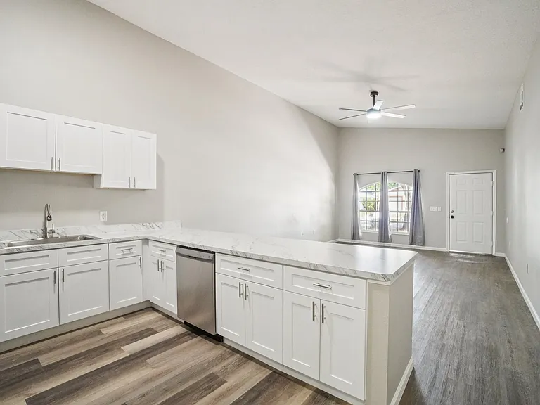 Bright, open-concept kitchen with ample cabinet space and modern contemporary flooring_perfect for entertaining.