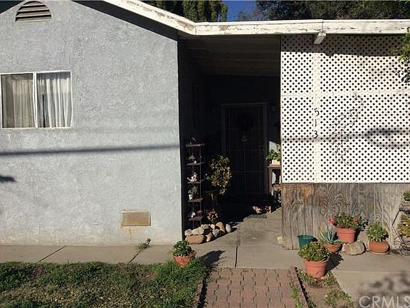 FRONT ENTRY WITH 2 CONCRETE SLAB SITTING AREAS