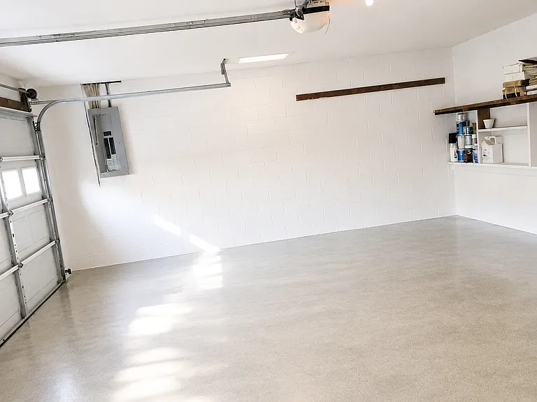 Double car garage with storage and shelved wall