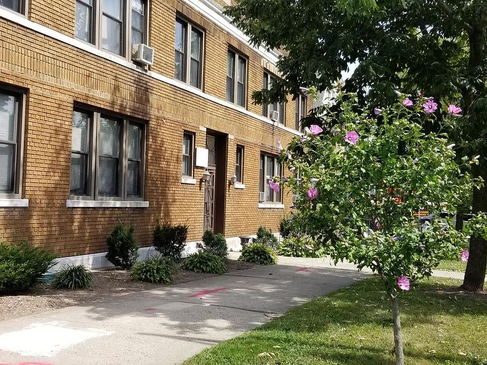 Front of building with summer landscaping and flowers. Improvements underway!