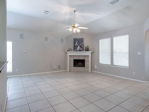 The large tile flooring runs the family room and formal dining area. Notice the surround sound here with recessed speakers as well.