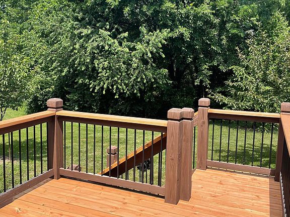 Back deck with view of green space. There are trees and small creek along with a walking path between you and the next row of houses.