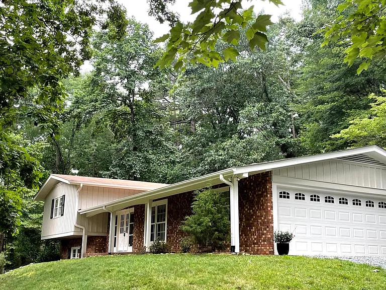 Attached two-car garage with large storage room for bikes, skis, strollers, and all your stuff! (new concrete driveway installed 2024, not pictured!)