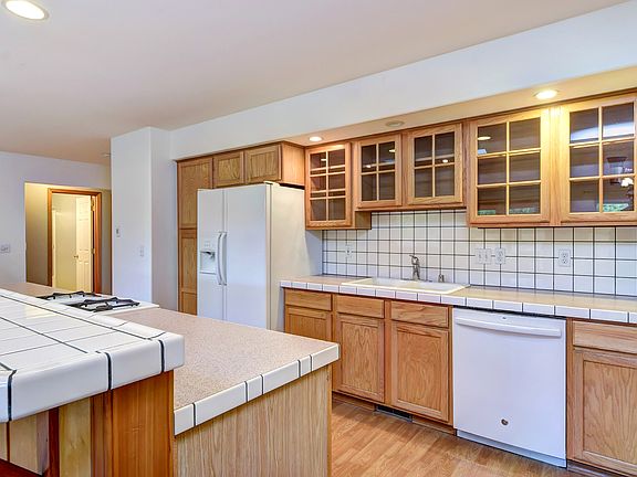 Beautiful cabinets and lots of counter space along with an island with eating area.