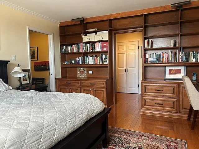 Bedroom with built in bookcases, entry to separate dressing room with walk-in closet.