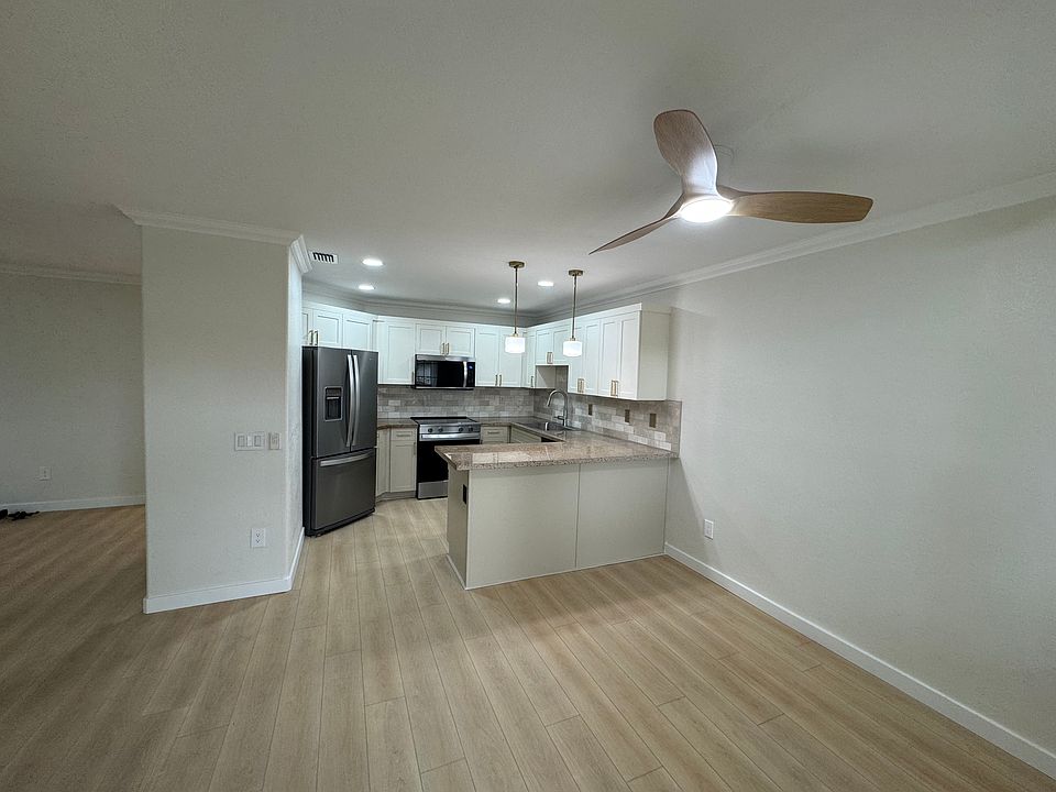 Kitchen dining area with all new appliances, ceiling fans, luxury vinyl, flowering throughout, new door opens to patio deck