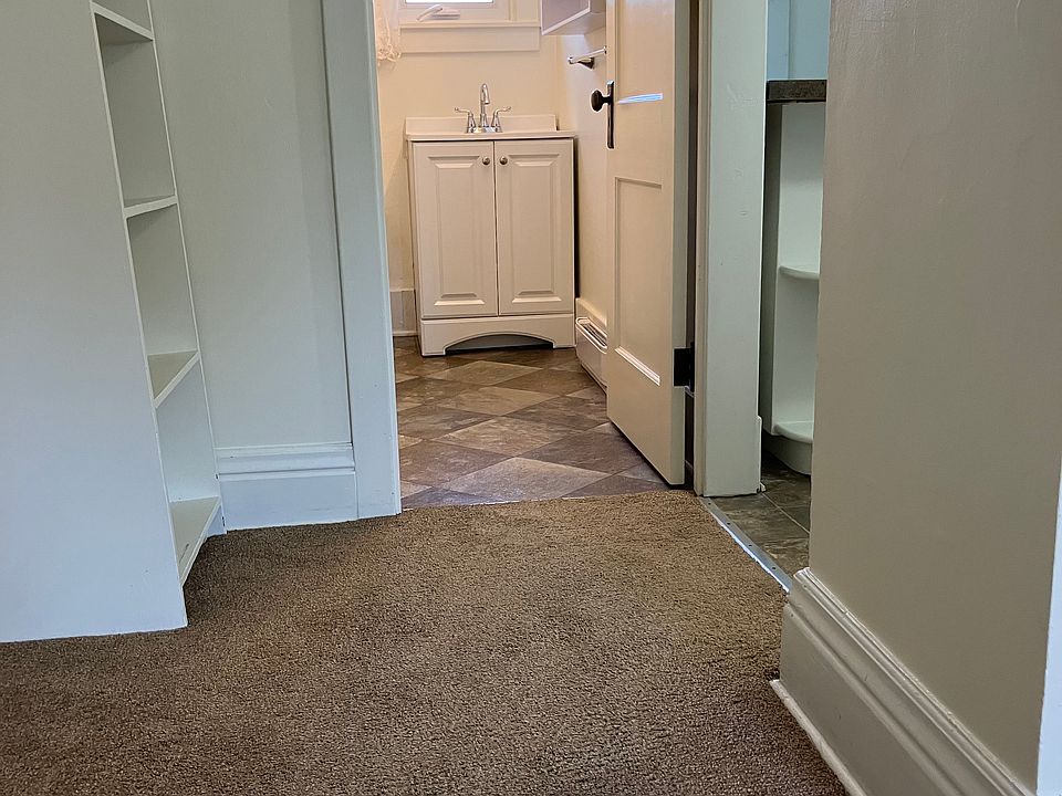 Hallway into bathroom and kitchen on right