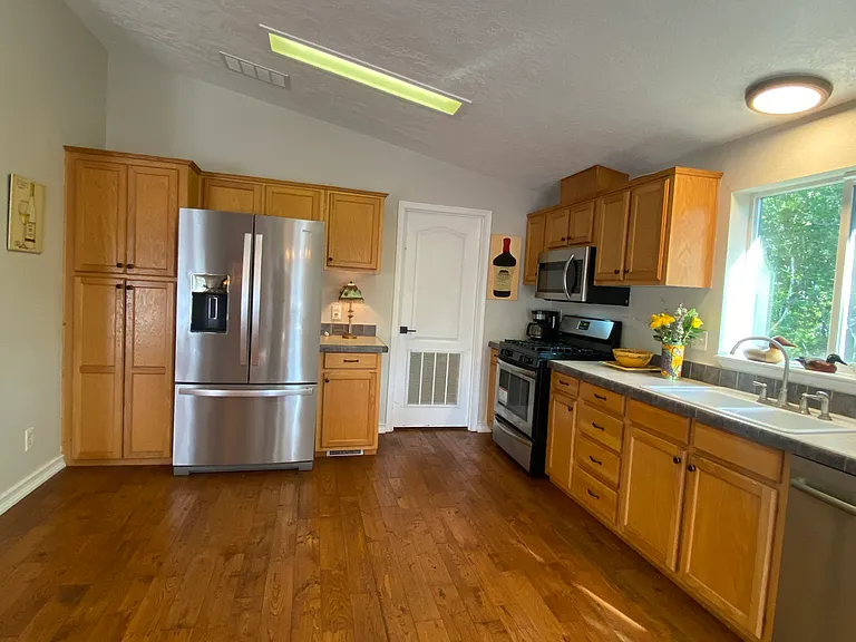 Spacious, Fully Stocked Kitchen with Abundant Cabinet Storage and Stainless Appliances _ French_Door Refrigerator with Water/Ice, Gas Range, and Microwave