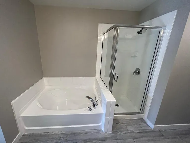 Newly reglazed tub and shower at Master bathroom for a clean and updated look.