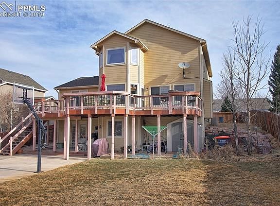 Walkout lower level with a covered patio, extensive trex deck w/stairs to the yard, flat area for children's play equipment, a sports court & backs to neighborhood open space