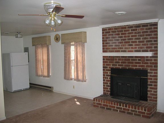 Living room with brick fireplacde