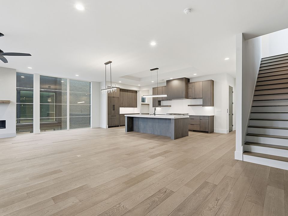 Spacious open floor plan featuring a designer kitchen with large island, modern finishes, and abundant natural light.