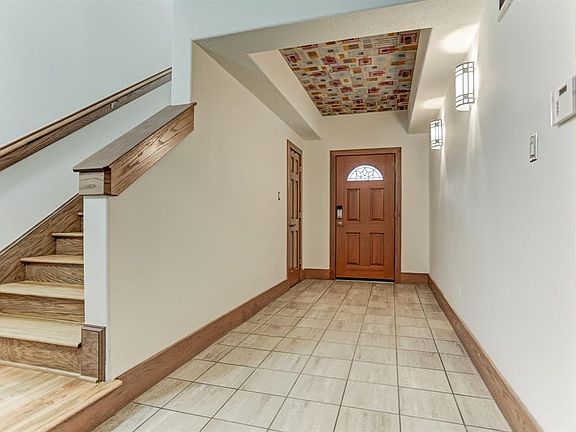 Nice private tiled entry with recessed ceiling, and beautiful hardwood landing and stairs to kitchen and living area!