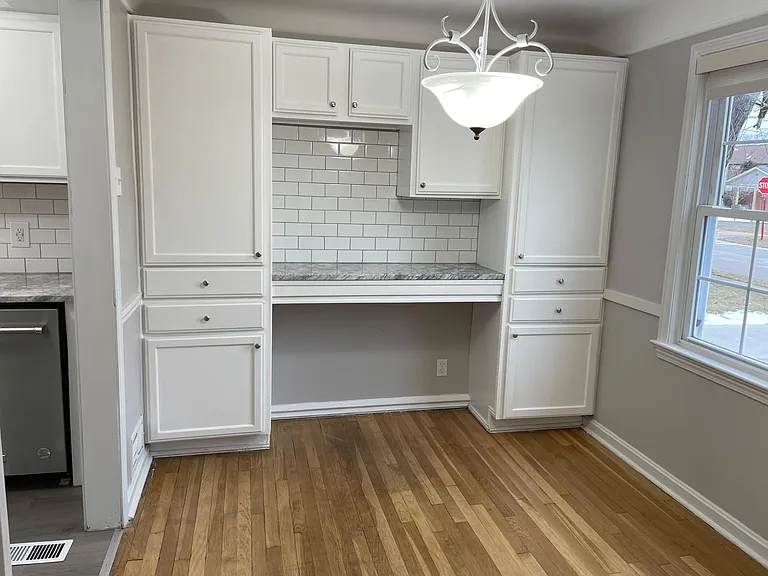 Dining room w/ custom built-in cabinets and granite counter