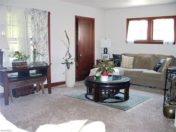 Living room with door to entry way with closet