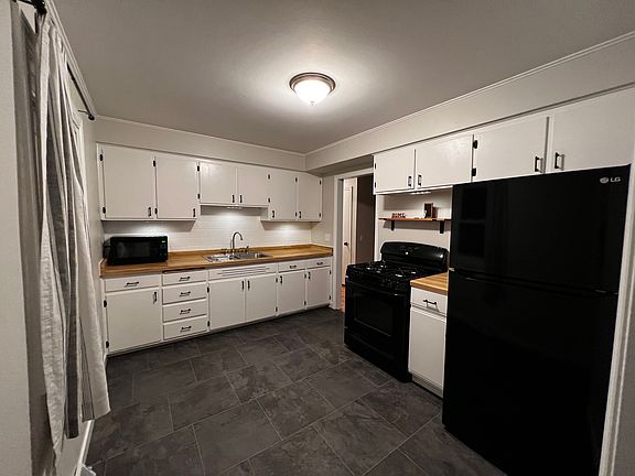 Updated kitchen with black appliances, new flooring, new paint and new ceiling and undercabinet lighting.