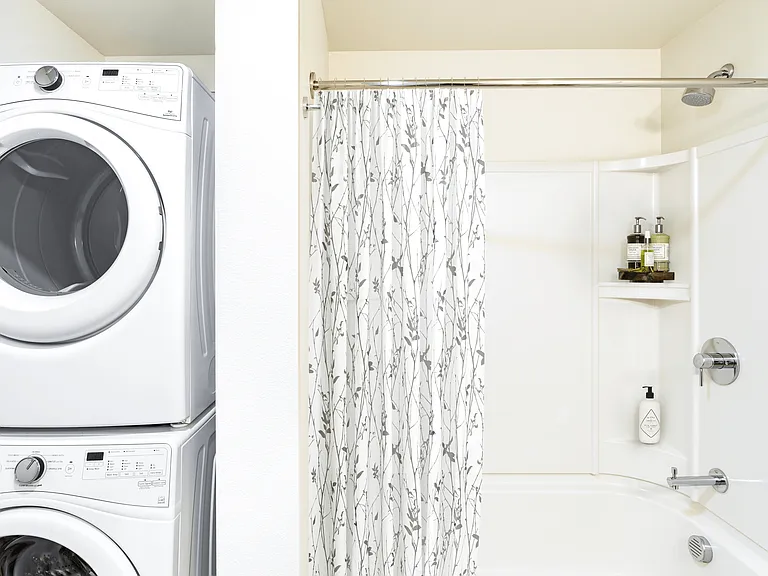 An efficient bath with in-home laundry at Modera Belmont, pairing clean design and everyday convenience just steps from Belmont's walkable shops and cafes.