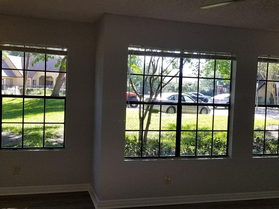 Wall of windows overlook green area.