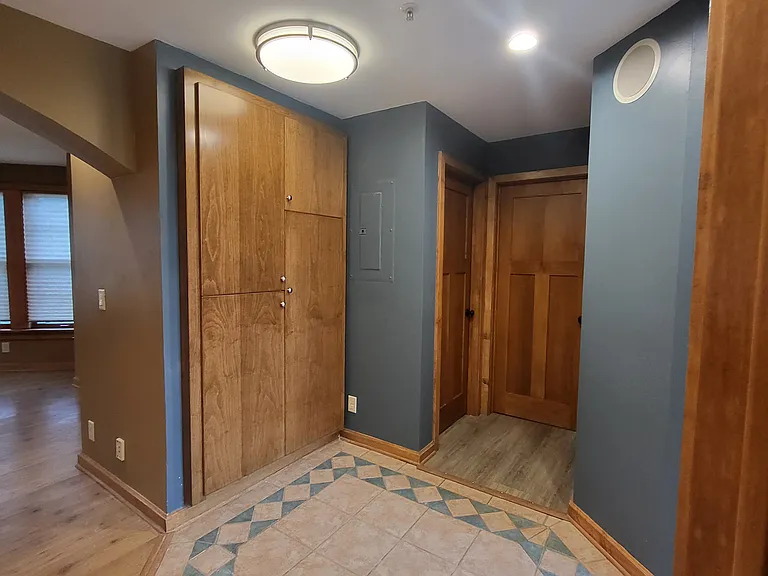 view from bathroom into Bdrm hall & broom / linen closet