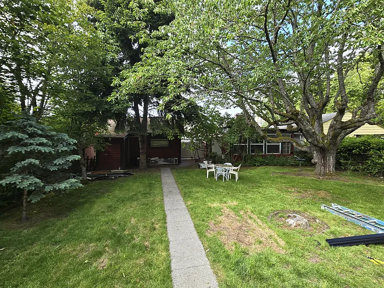 Back Garden of Home, Garage not included is to the left and small guesthouse, when occupied is rented separately.