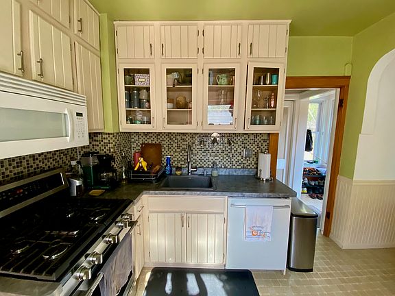 Kitchen with tile backsplash, gas range, and dishwasher