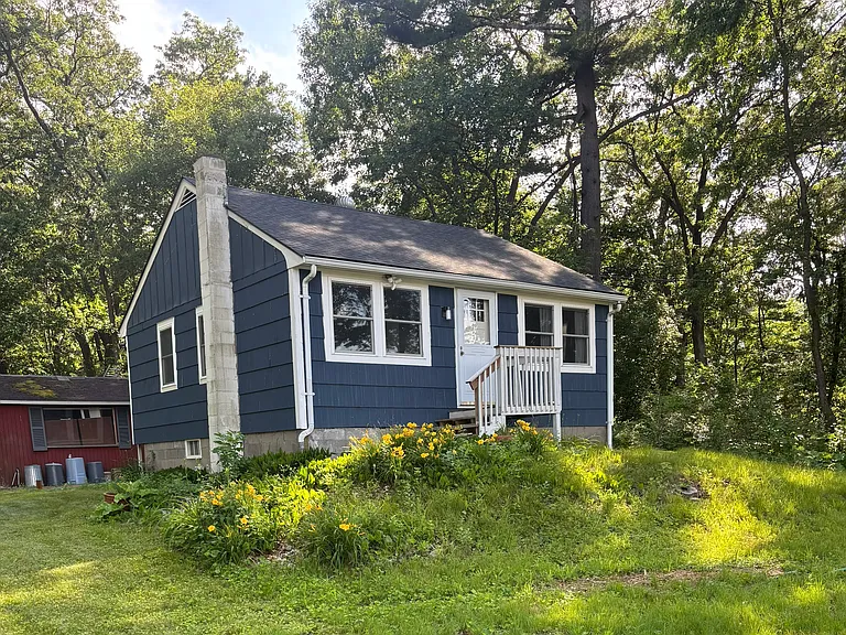 Front yard of house.
Furnished house with linens, dishes, etc