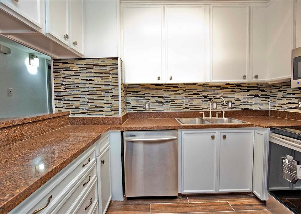 6x6 Kitchen - Kitchen has granite counters, white cabinets and stainless steel appliances. Notice the pass-through to the left.