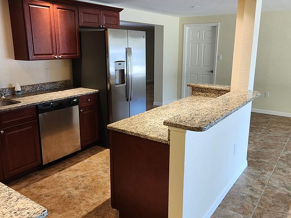 kitchen with granite countertops and stainless steel appliances