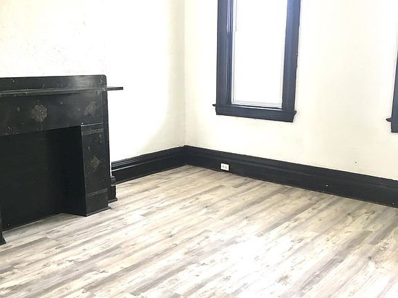 HUGE living room has lots of lights and NEW floors!