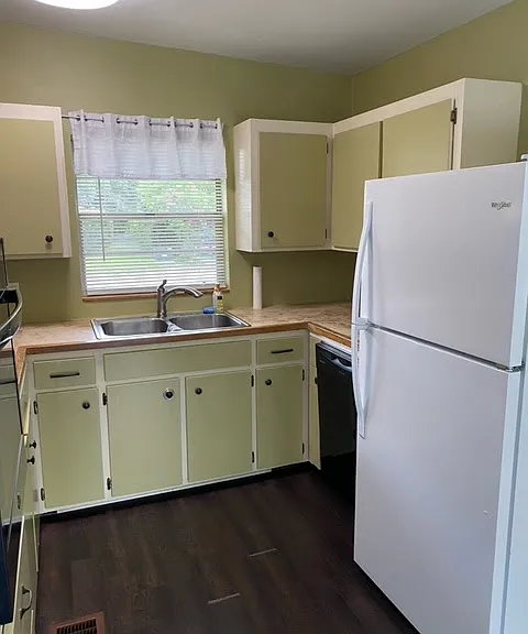 Clean and bright kitchen with stainless steel sink and plenty of storage. New oven and stove top to the left, dishwasher to the right is about a year old.