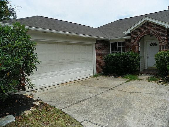 Corner lot with curving driveway leads to 2 car attached garage.