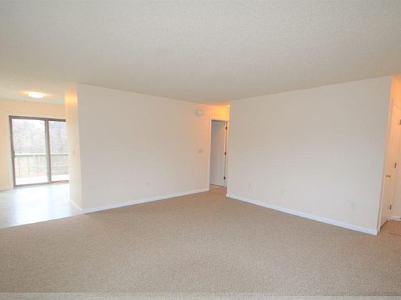 Another view of the living area; kitchen on the left with slider doors leading to the private deck.