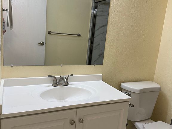 Bathroom with new toilet, cabinet and mirror