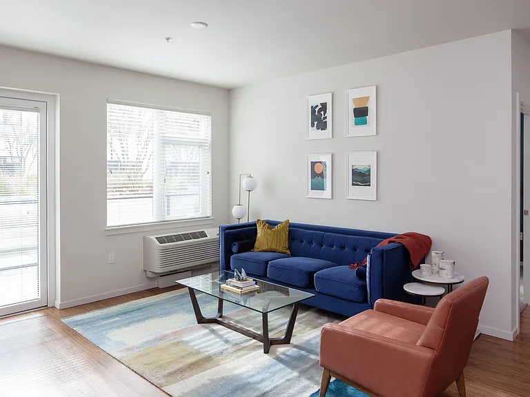Grant Park Village living room shot with blue couch and orange leather chair