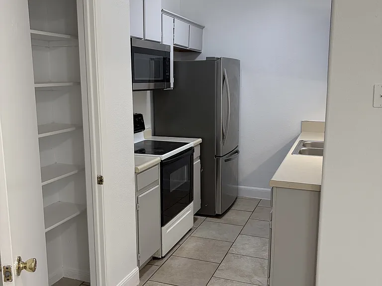 Pantry, electric stove, microwave, refrigerator, double sink