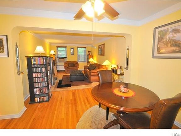 Spacious living room with hardwood floors and separate dining area.