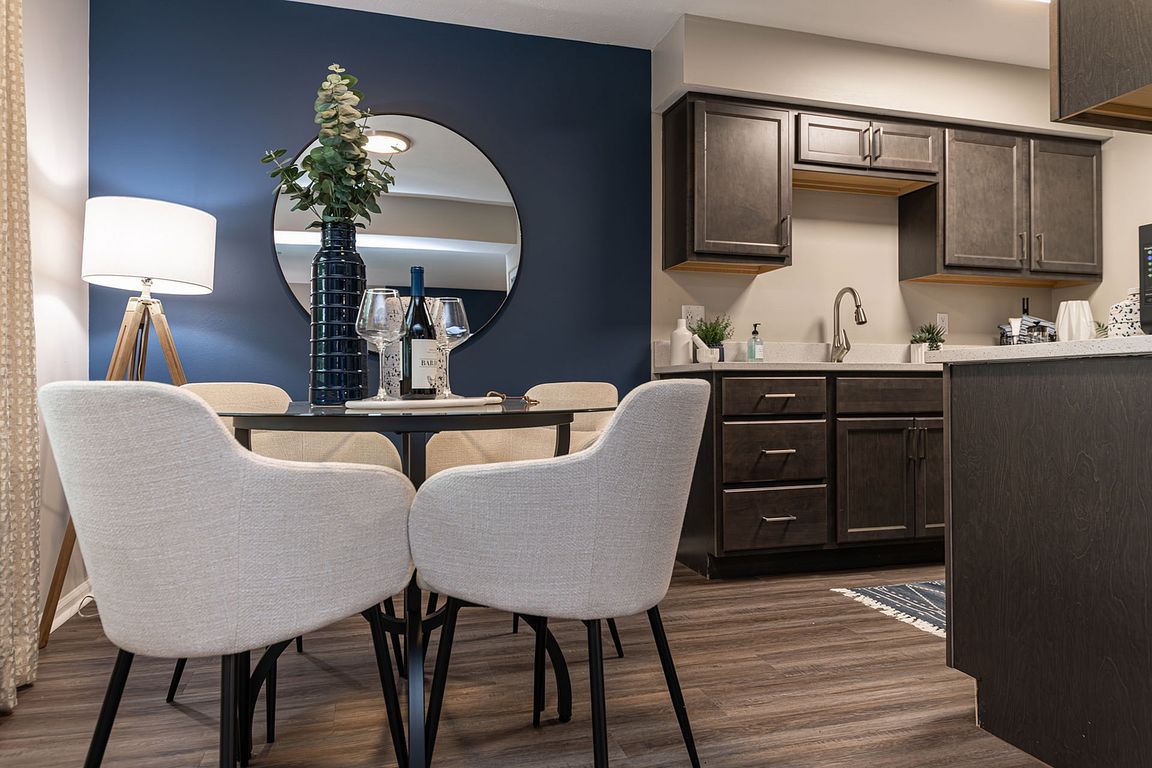 Kitchen and dining area with hardwood-style flooring